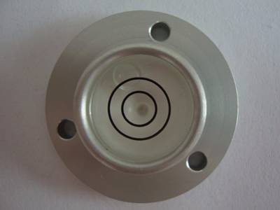 There is a metals bubble level vial with fixing hole on the ground.